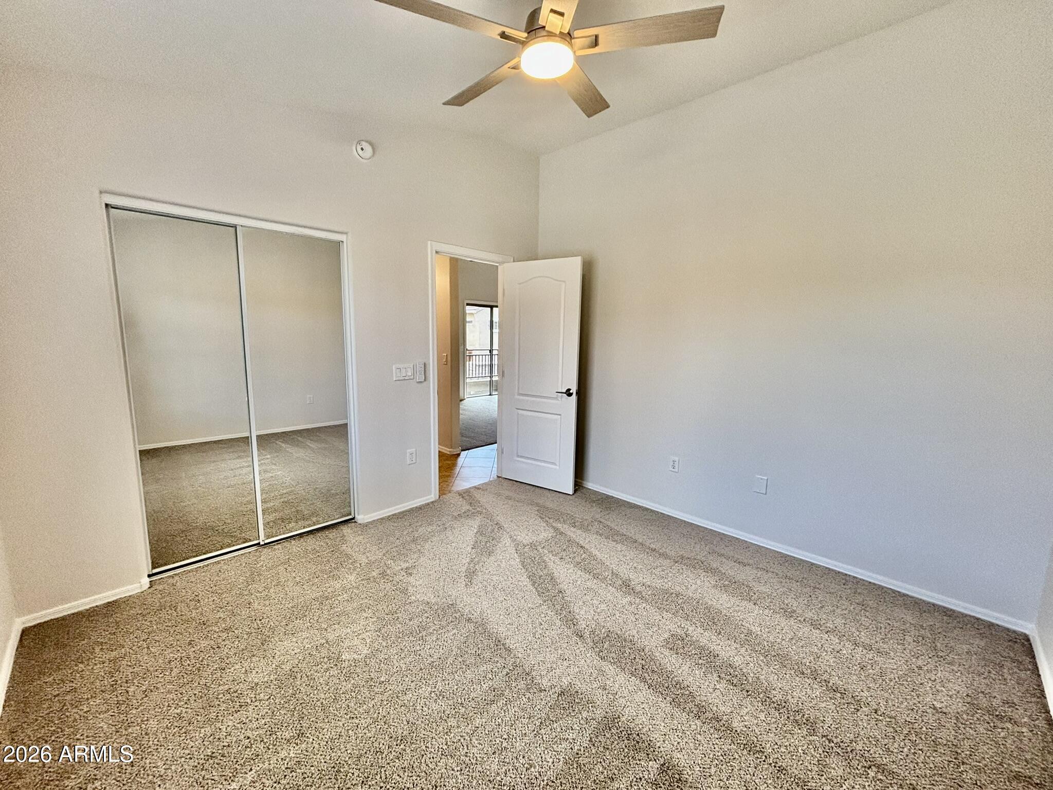 1350 South Greenfield Road, Unit 2041 Mesa, AZ 85206 - Photo 24 of 33 a view of an empty room with a ceiling fan