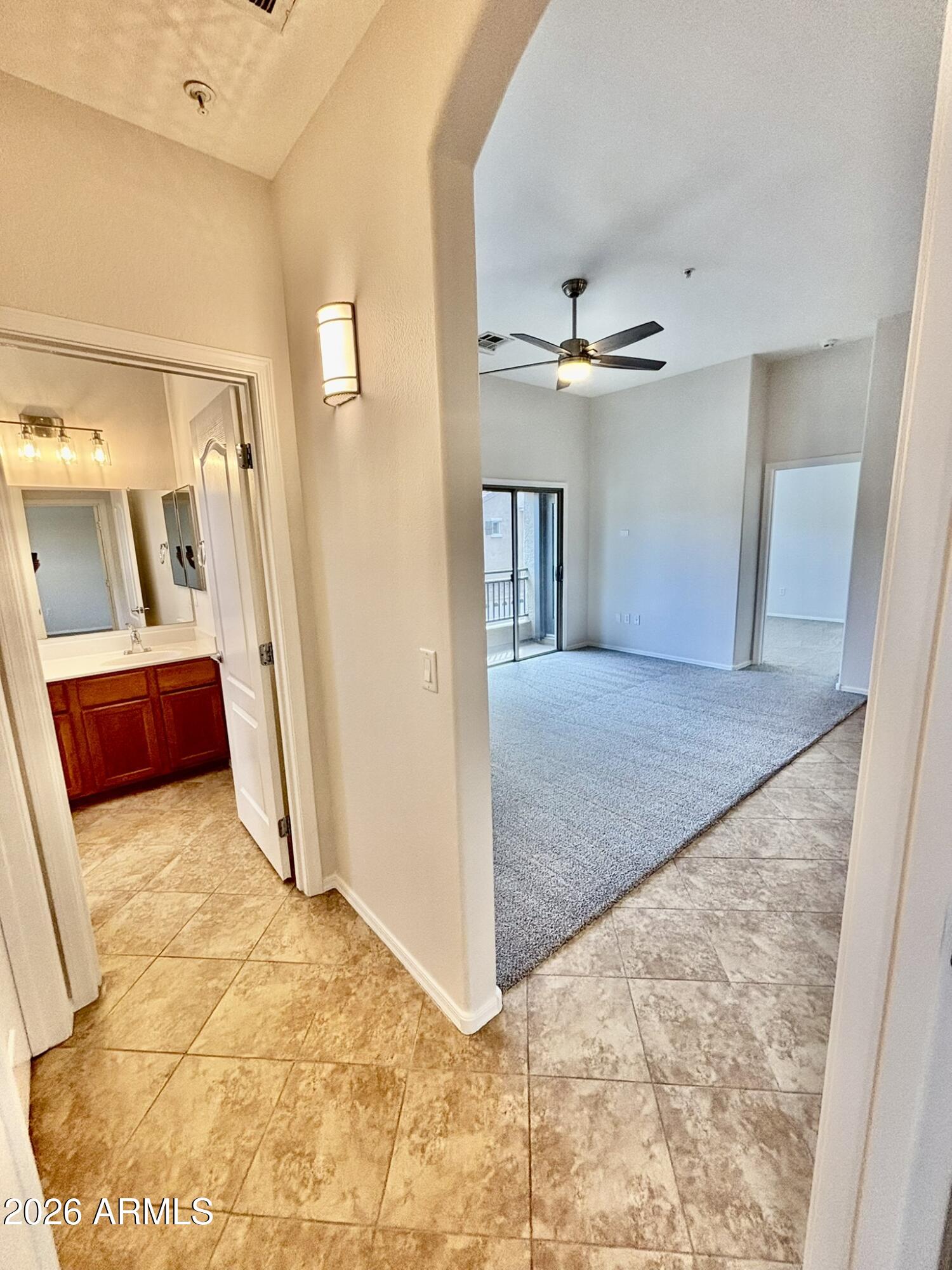 1350 South Greenfield Road, Unit 2041 Mesa, AZ 85206 - Photo 27 of 33 a view of a hallway with a chandelier fan and windows