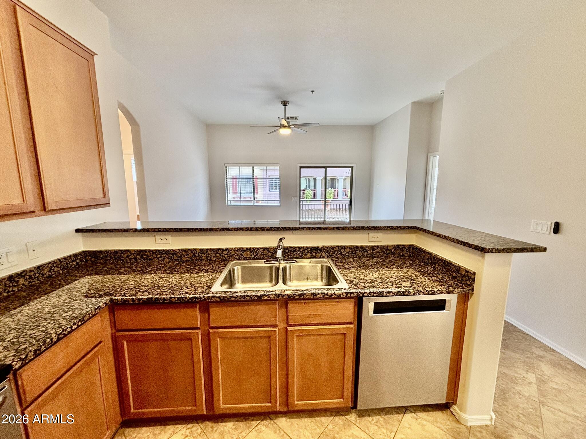 1350 South Greenfield Road, Unit 2041 Mesa, AZ 85206 - Photo 6 of 33 a kitchen with granite countertop a sink and a stove top oven