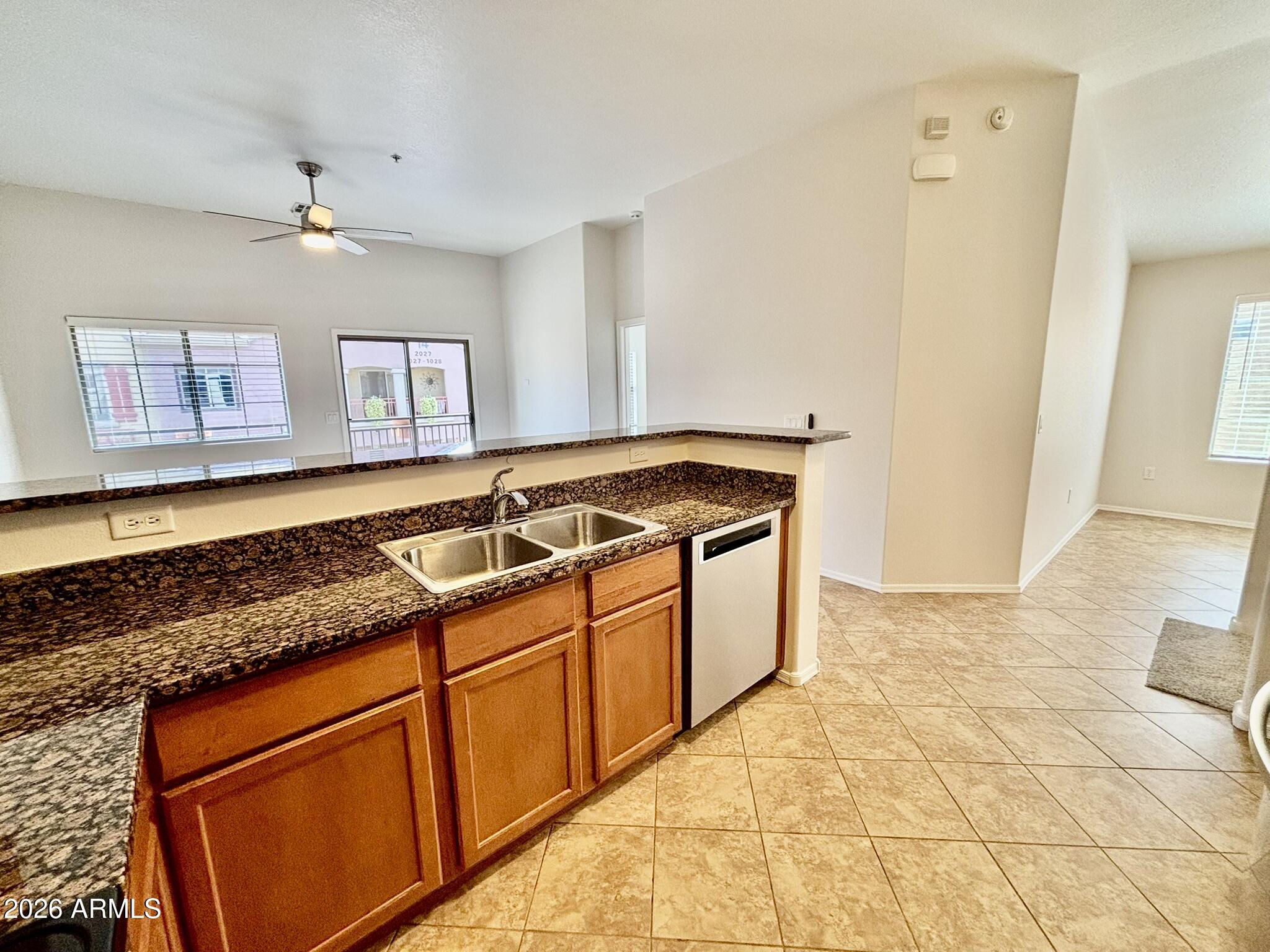 1350 South Greenfield Road, Unit 2041 Mesa, AZ 85206 - Photo 7 of 33 a kitchen with stainless steel appliances granite countertop a sink stove and cabinets