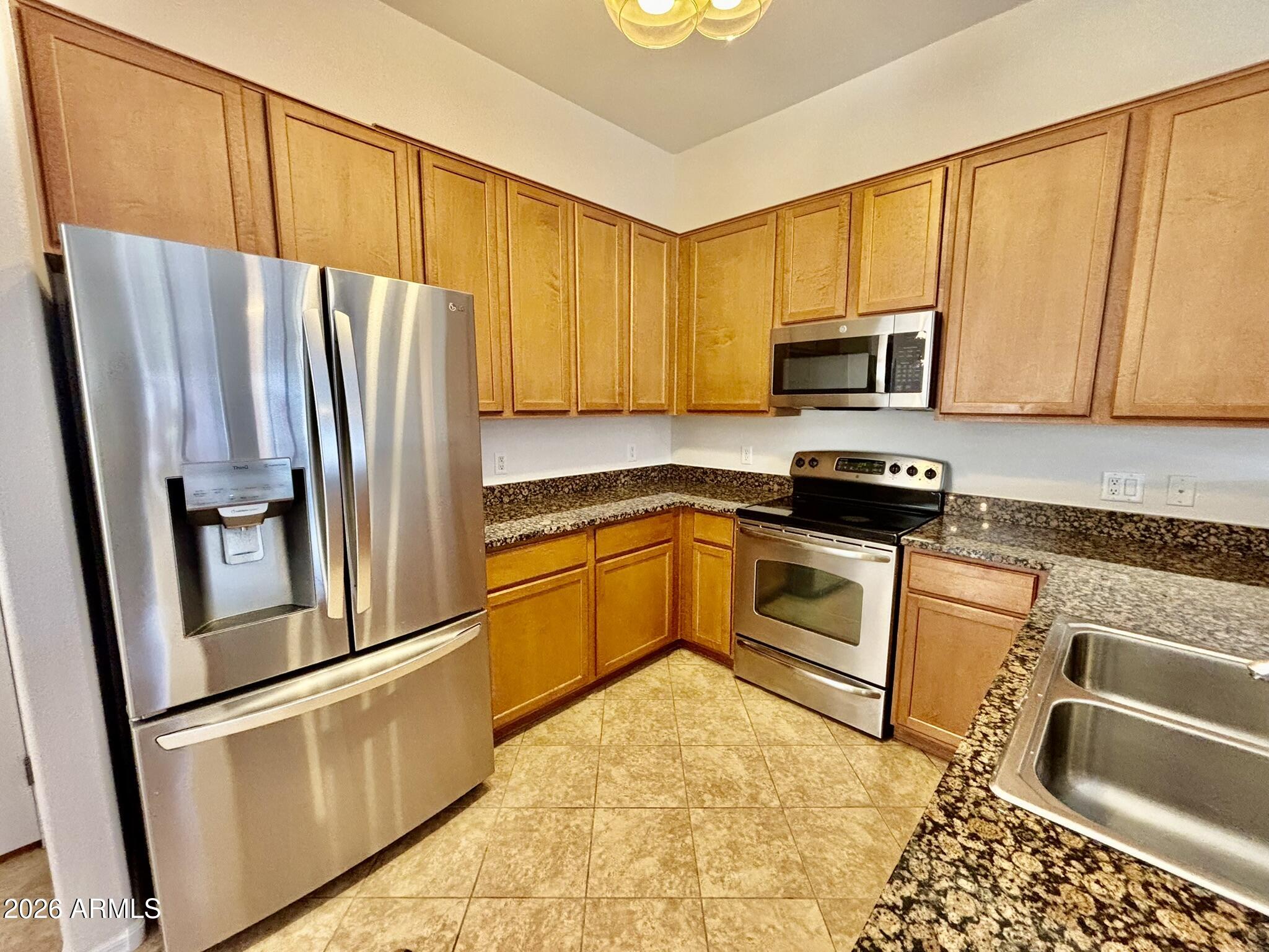 1350 South Greenfield Road, Unit 2041 Mesa, AZ 85206 - Photo 10 of 33 a kitchen with a refrigerator sink and microwave
