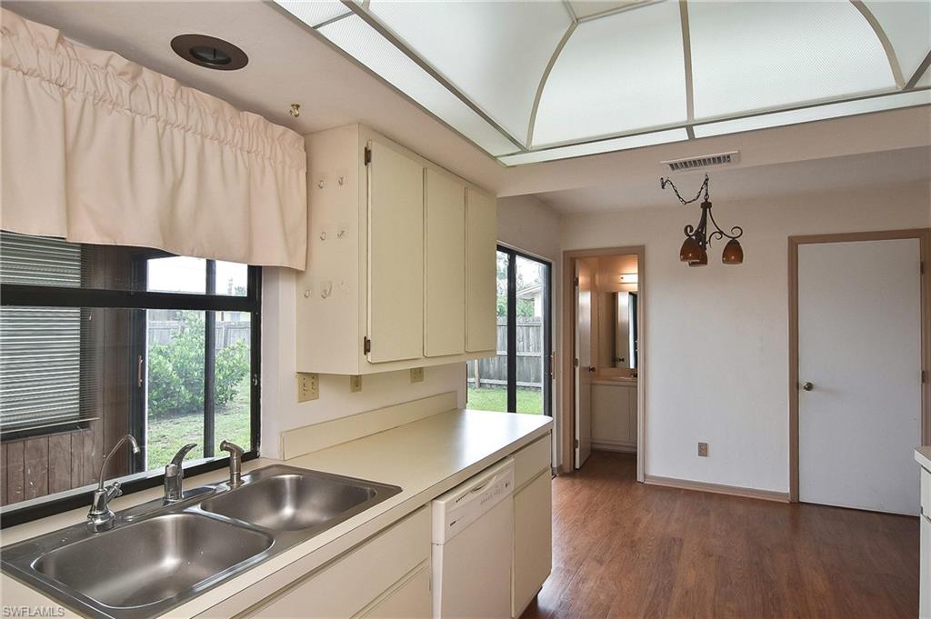 18557 Coconut Road Fort Myers, FL 33967 - Photo 34 of 50 a kitchen with a sink refrigerator and cabinets