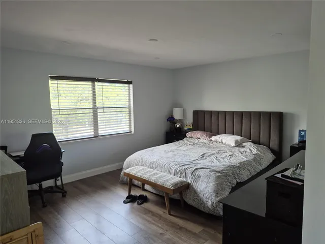 a bed sitting in a bedroom next to a window