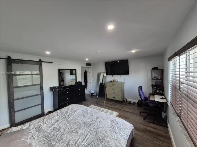 a bed room with a television and a dresser
