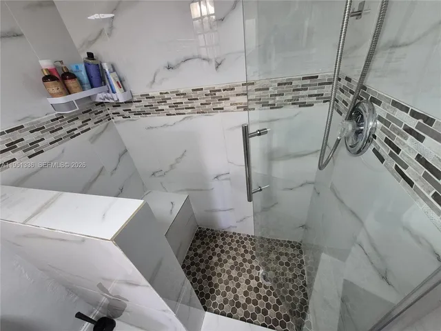 a bathroom with a bathtub and shower