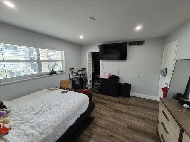 a bed room with a bed and a flat screen tv