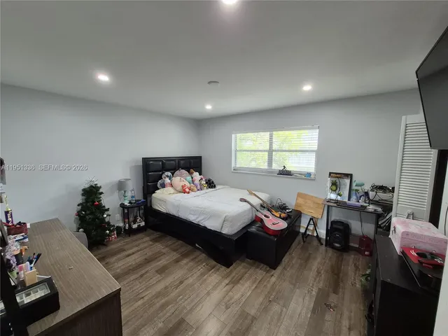 a bed room with a bed window and a dresser