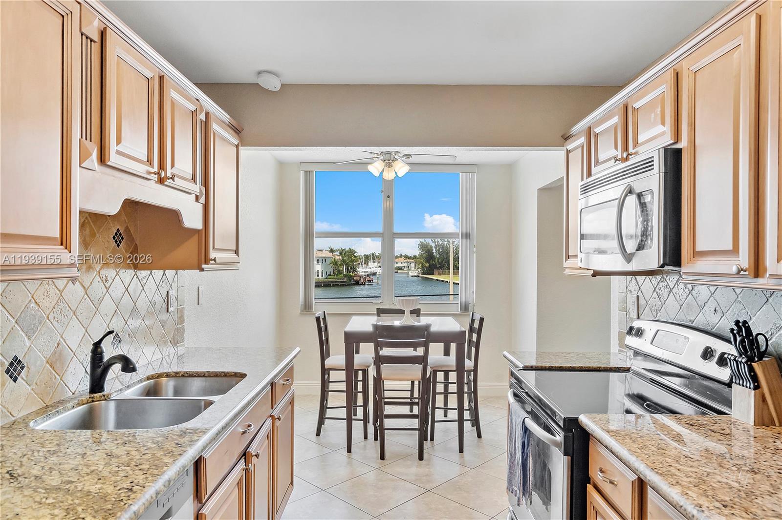 1401 South Ocean Drive, Unit 301 Hollywood, FL 33019 - Photo 11 of 48 a kitchen with stainless steel appliances granite countertop a sink stove and refrigerator