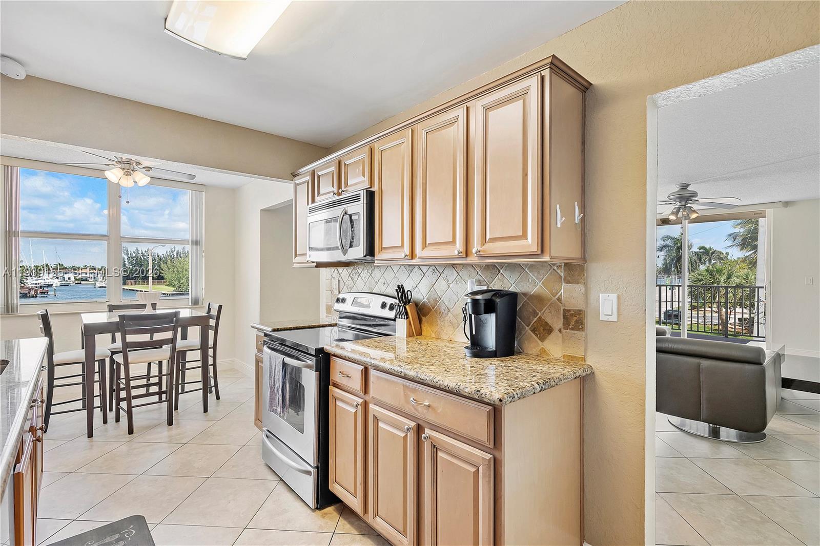 1401 South Ocean Drive, Unit 301 Hollywood, FL 33019 - Photo 12 of 48 a kitchen with stainless steel appliances granite countertop a stove a sink and a microwave