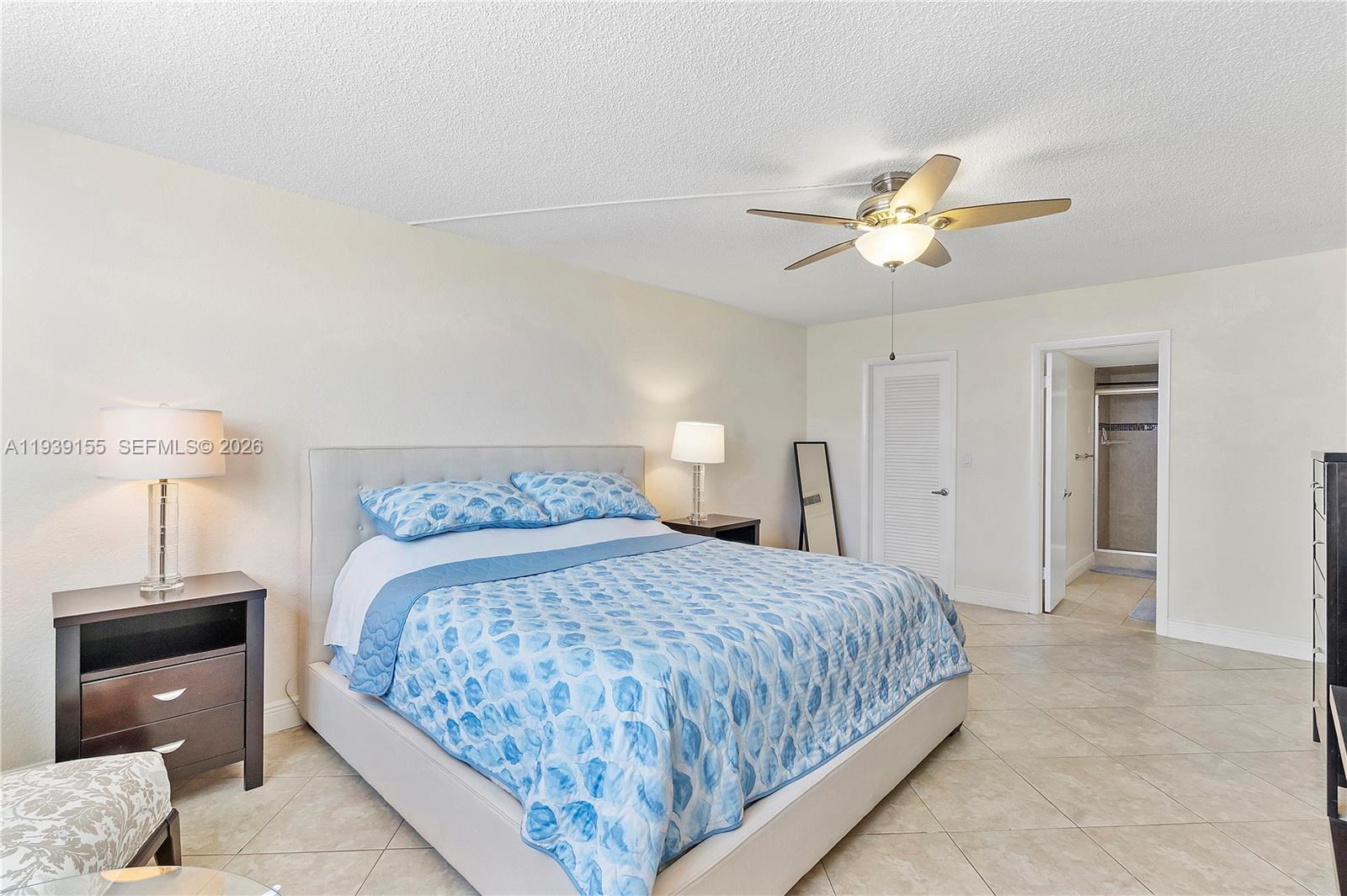 1401 South Ocean Drive, Unit 301 Hollywood, FL 33019 - Photo 21 of 48 a bedroom with a bed and a chandelier