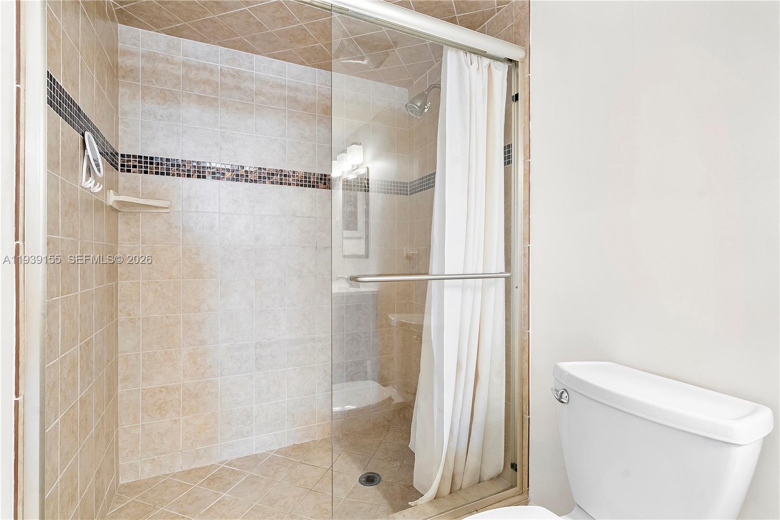 1401 South Ocean Drive, Unit 301 Hollywood, FL 33019 - Photo 24 of 48 a bathroom with a shower and a toilet