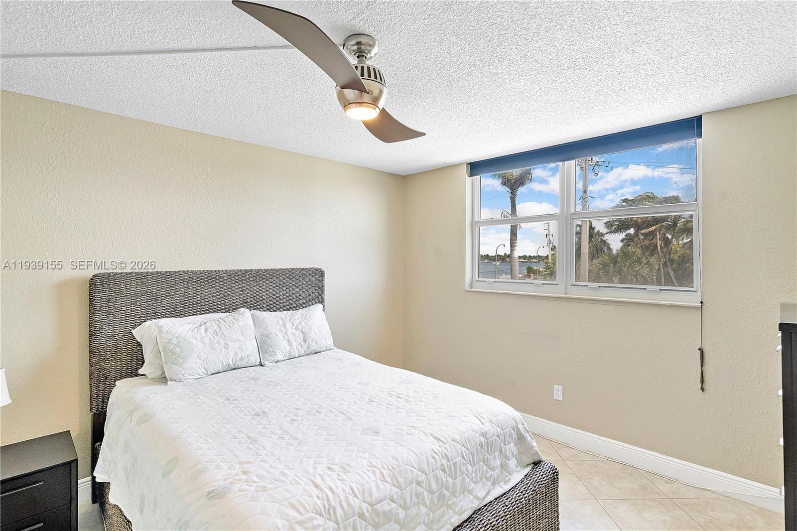 1401 South Ocean Drive, Unit 301 Hollywood, FL 33019 - Photo 26 of 48 a bedroom with a bed and a painting on the wall