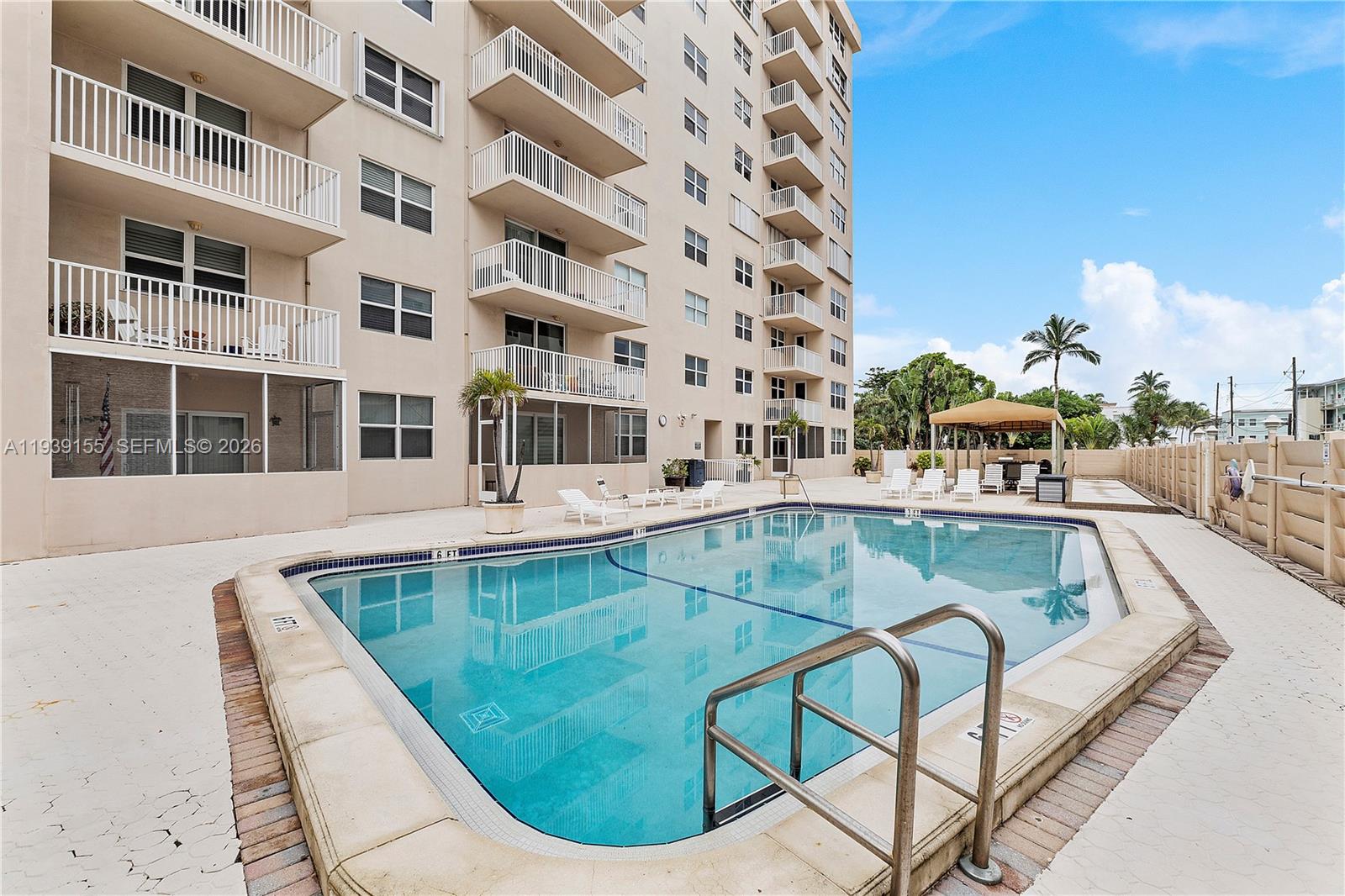 1401 South Ocean Drive, Unit 301 Hollywood, FL 33019 - Photo 34 of 48 a view of a swimming pool with a lounge chair