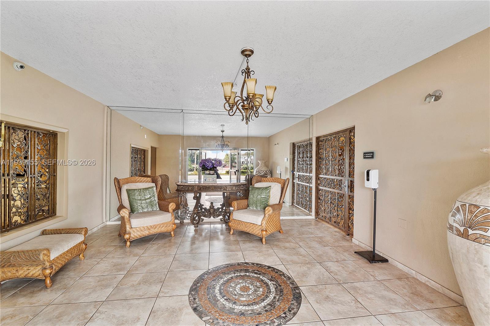 1401 South Ocean Drive, Unit 301 Hollywood, FL 33019 - Photo 38 of 48 a living room with furniture and a chandelier