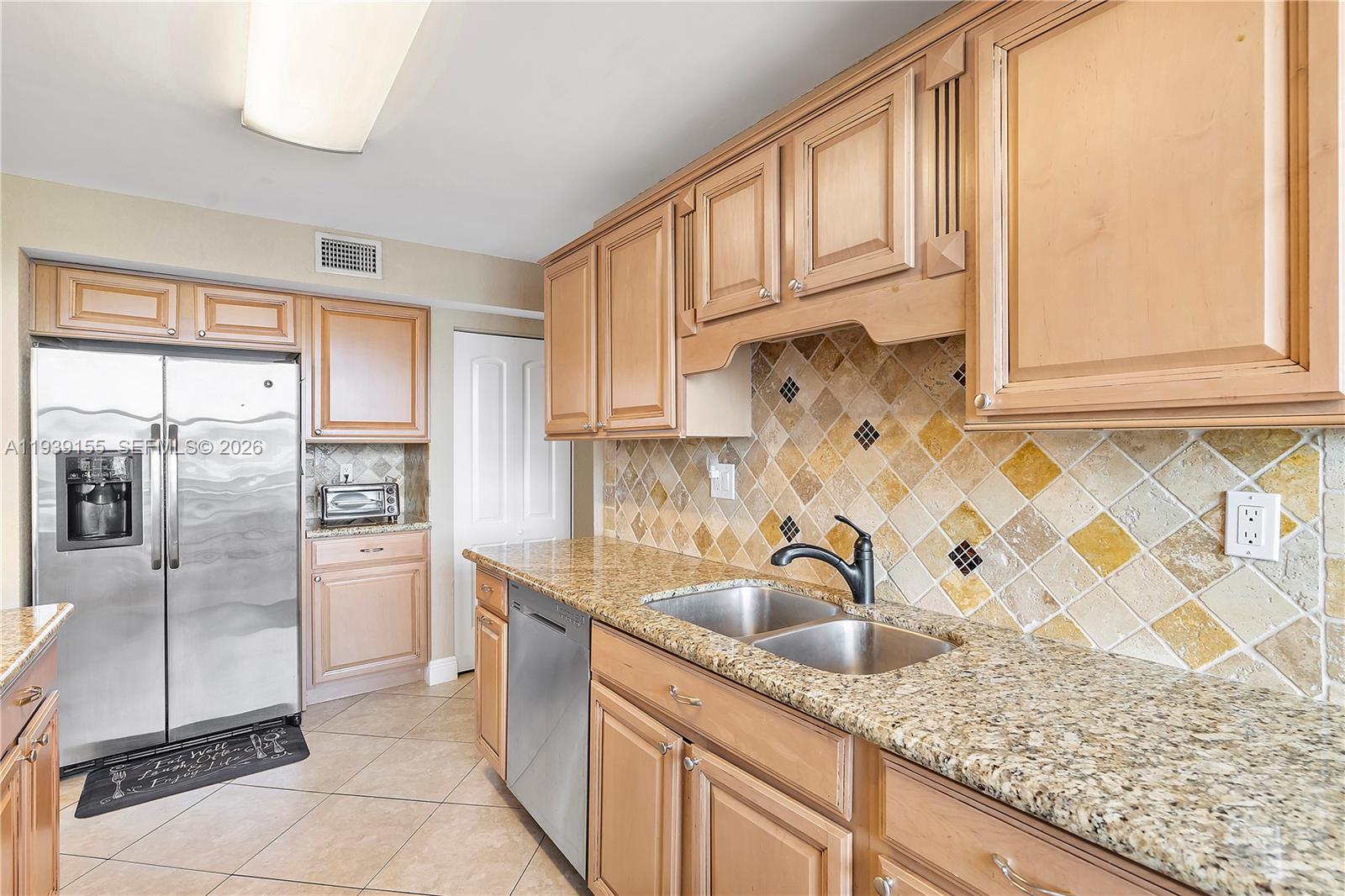 1401 South Ocean Drive, Unit 301 Hollywood, FL 33019 - Photo 8 of 48 a kitchen with stainless steel appliances granite countertop a sink and a refrigerator