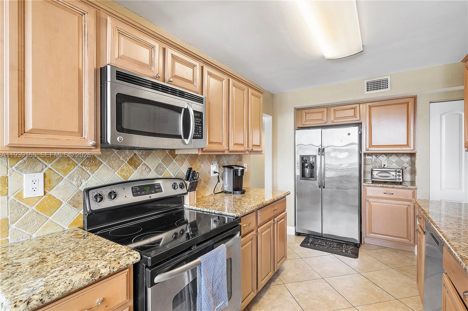 1401 South Ocean Drive, Unit 301 Hollywood, FL 33019 - Photo 9 of 48 a kitchen with stainless steel appliances granite countertop a stove microwave and refrigerator