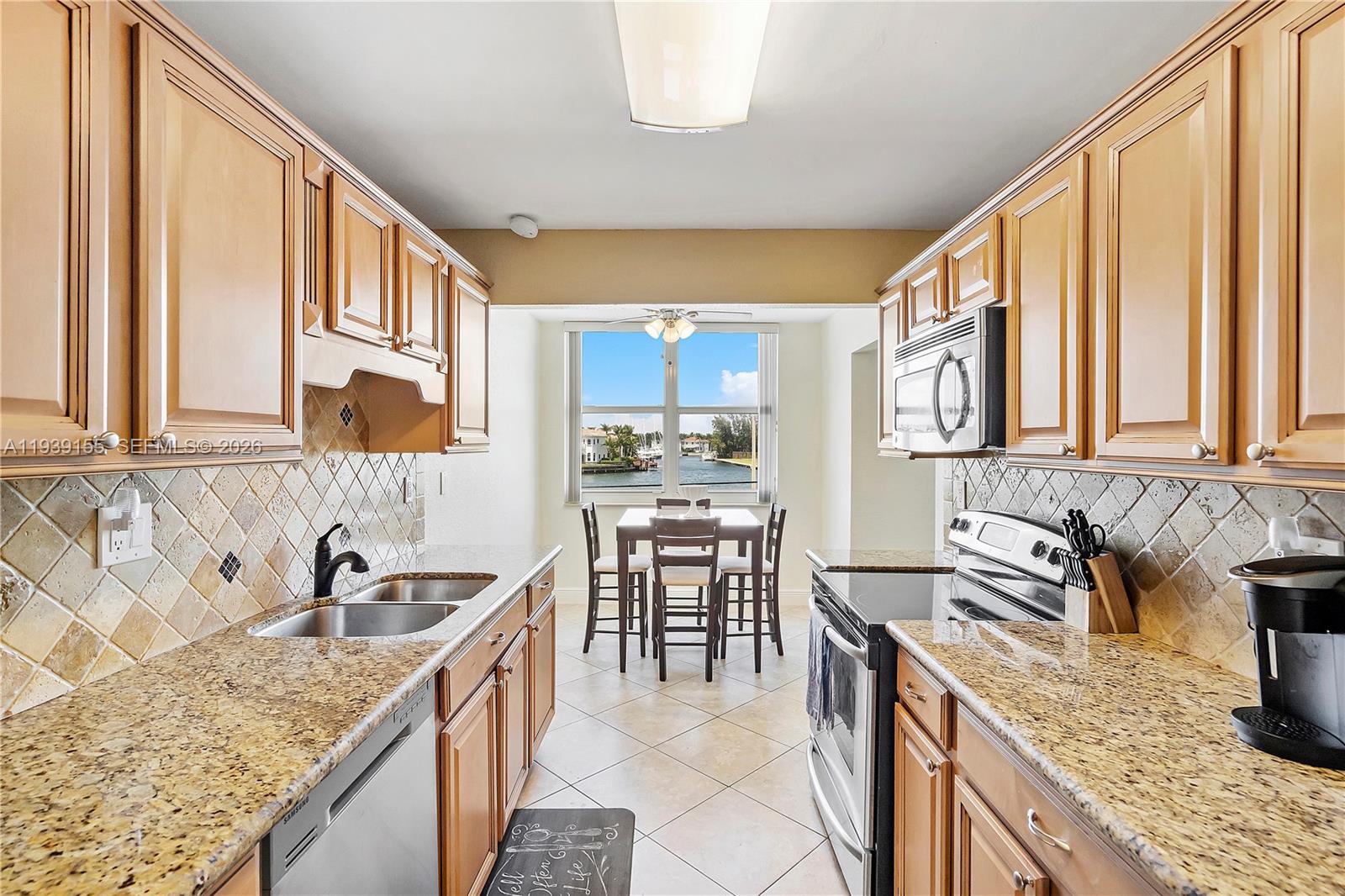 1401 South Ocean Drive, Unit 301 Hollywood, FL 33019 - Photo 10 of 48 a kitchen with stainless steel appliances granite countertop a sink stove and cabinets