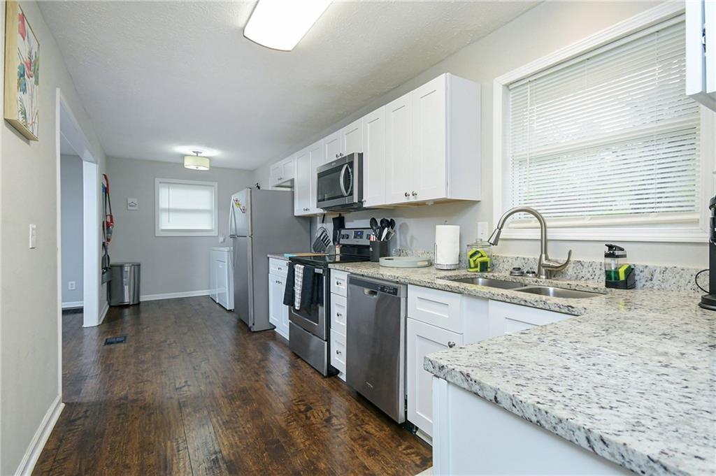 84 West Paulding Boulevard Dallas, GA 30157 - Photo 15 of 37 a kitchen with a sink stove and refrigerator