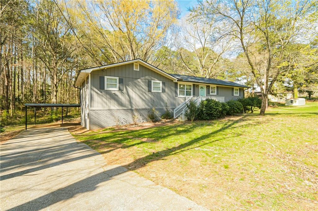 84 West Paulding Boulevard Dallas, GA 30157 - Photo 2 of 37 a front view of a house with a garden