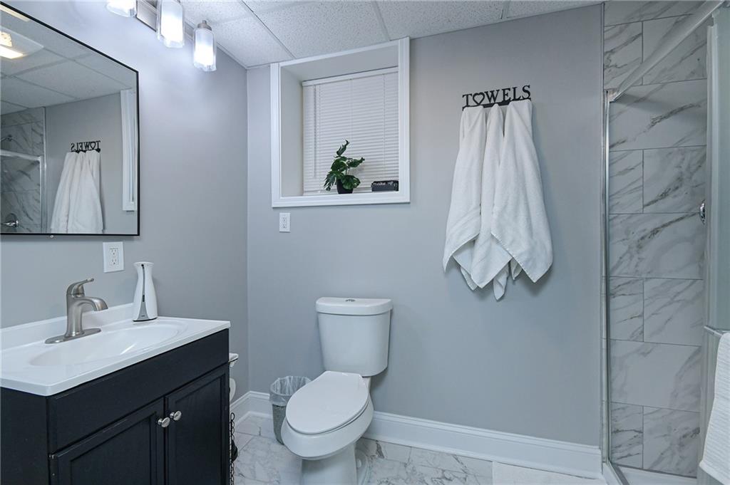 84 West Paulding Boulevard Dallas, GA 30157 - Photo 23 of 37 a bathroom with a toilet sink and mirror