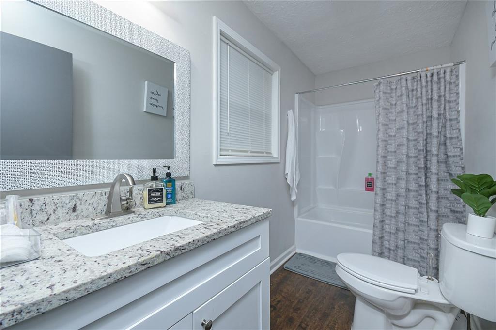 84 West Paulding Boulevard Dallas, GA 30157 - Photo 26 of 37 a bathroom with a granite countertop sink mirror vanity and toilet