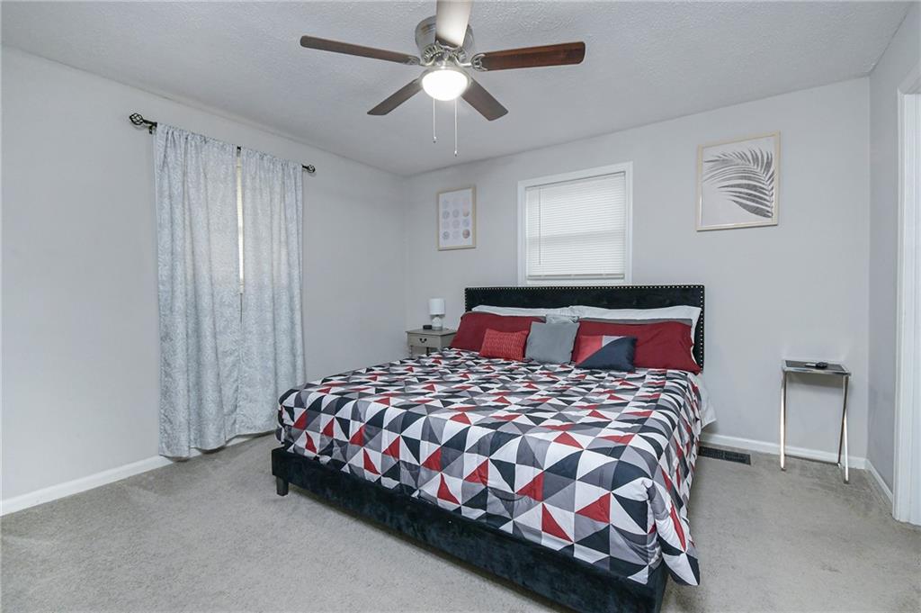 84 West Paulding Boulevard Dallas, GA 30157 - Photo 27 of 37 a bedroom with a bed and a chandelier