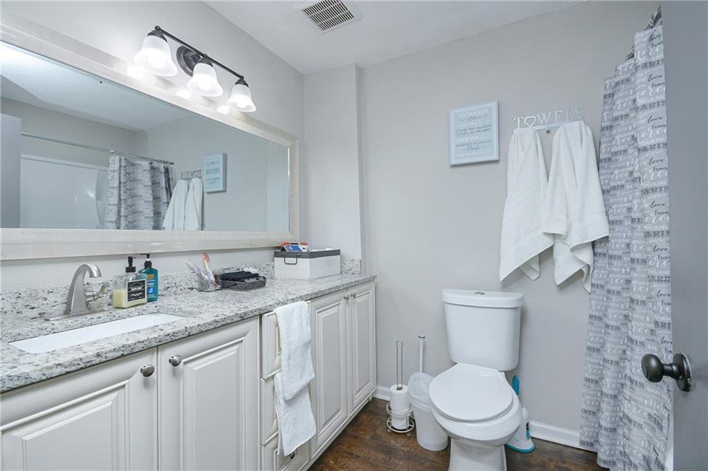 84 West Paulding Boulevard Dallas, GA 30157 - Photo 28 of 37 a bathroom with a granite countertop toilet sink and mirror