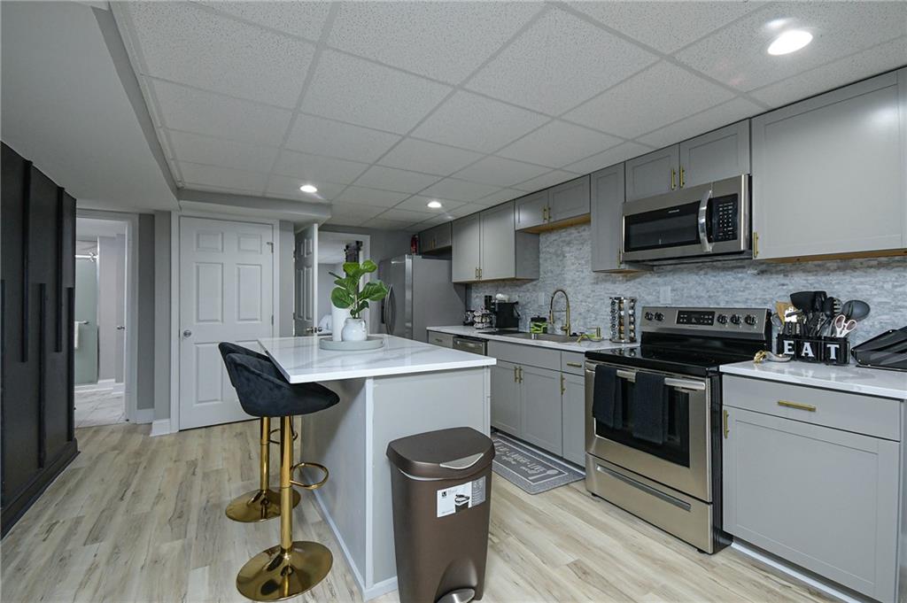 84 West Paulding Boulevard Dallas, GA 30157 - Photo 5 of 37 a kitchen with stainless steel appliances granite countertop a stove a sink dishwasher and a refrigerator with wooden floor