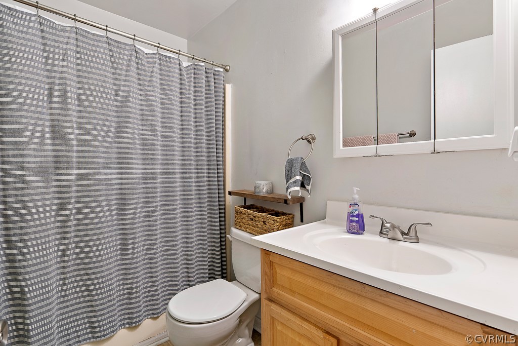 5022 Wilconna Road Chesterfield, VA 23832 - Photo 11 of 27 a bathroom with a sink a toilet and a mirror
