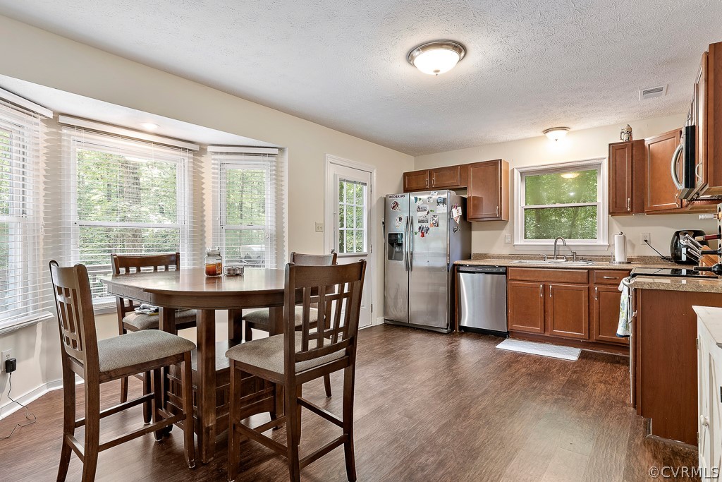 5022 Wilconna Road Chesterfield, VA 23832 - Photo 8 of 27 a kitchen with stainless steel appliances a dining table chairs and wooden floor