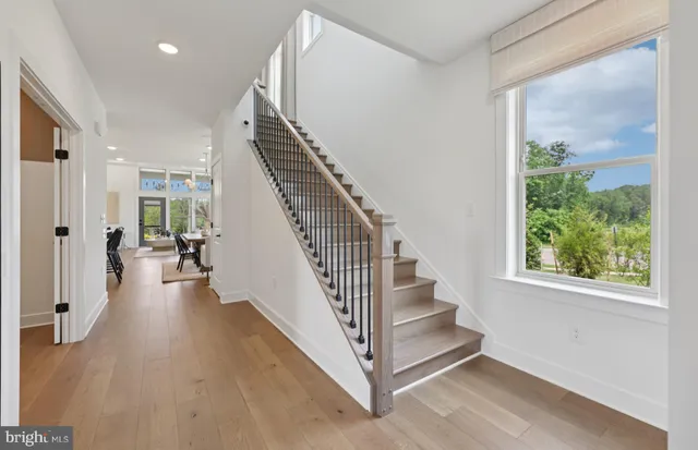 a view of entryway and hall with wooden floor
