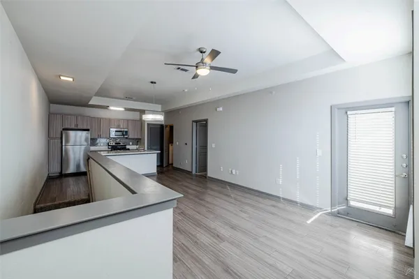 a view of a kitchen with a sink and wooden floor