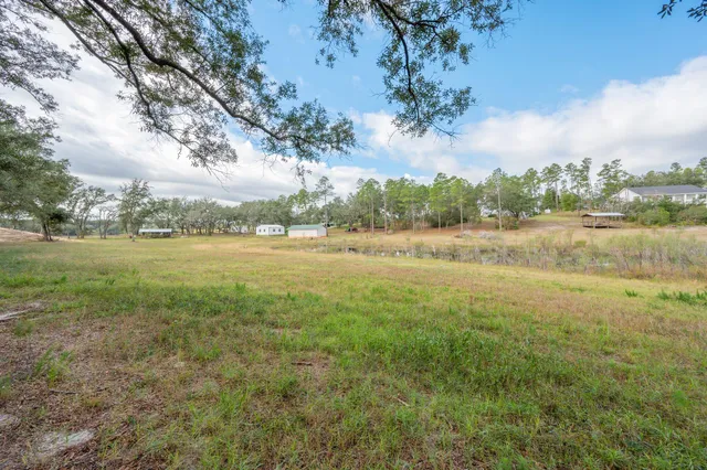 a view of a lake with houses in the back