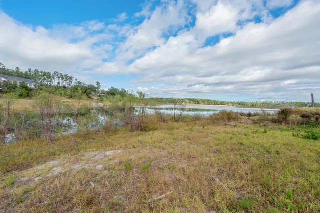 a view of a lake with houses in the back