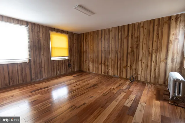 a view of a room with wooden floor and sliding window