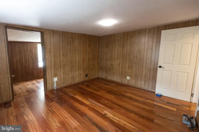 a view of a room with wooden floor