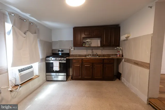 a kitchen with stainless steel appliances a stove a microwave and a refrigerator