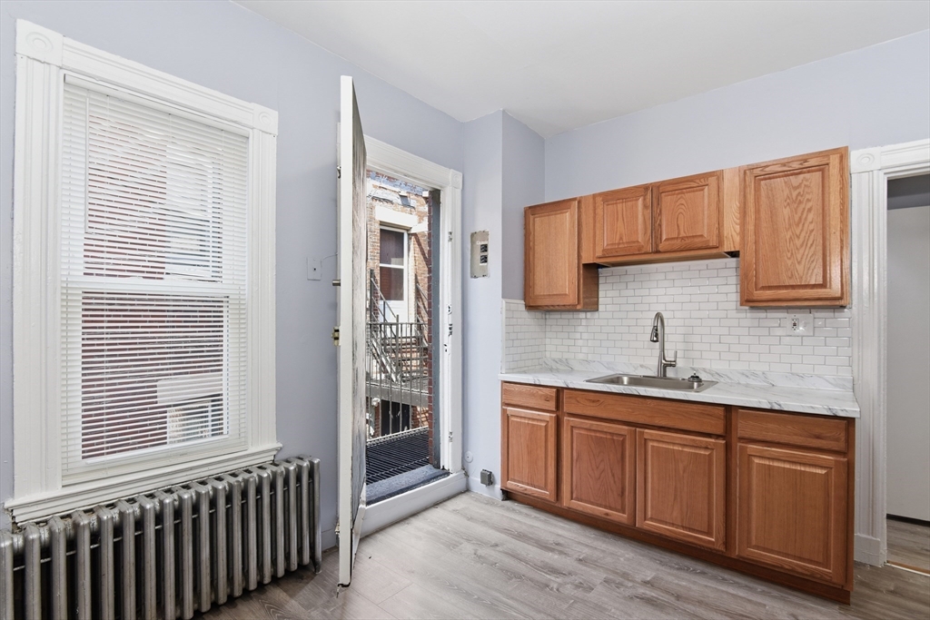 a kitchen with sink cabinets and window