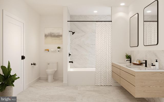 a bathroom with a bathtub a sink a toilet and a shower