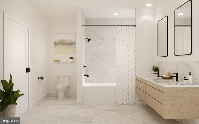 a bathroom with a bathtub a sink a toilet and a shower