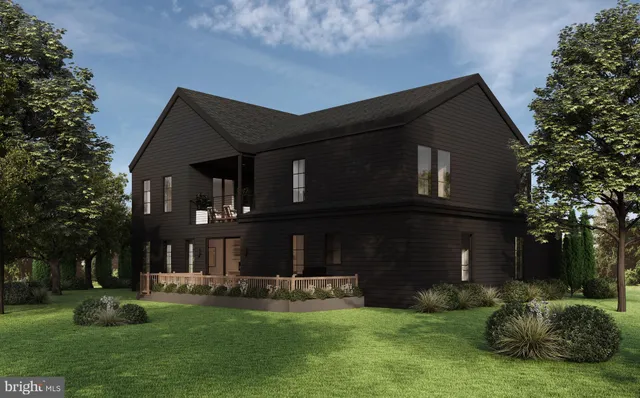 a front view of a house with a yard table and chairs