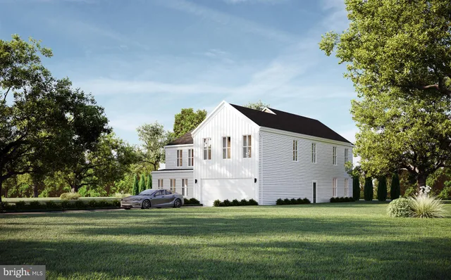 a front view of a house with a yard and trees