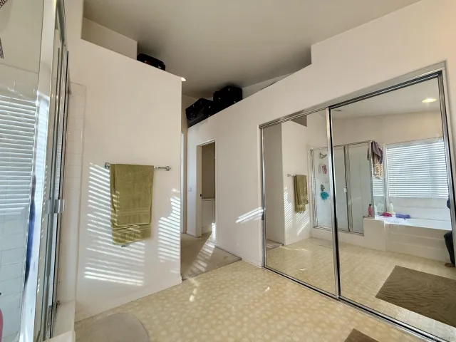 a view of a hallway with a glass door shower
