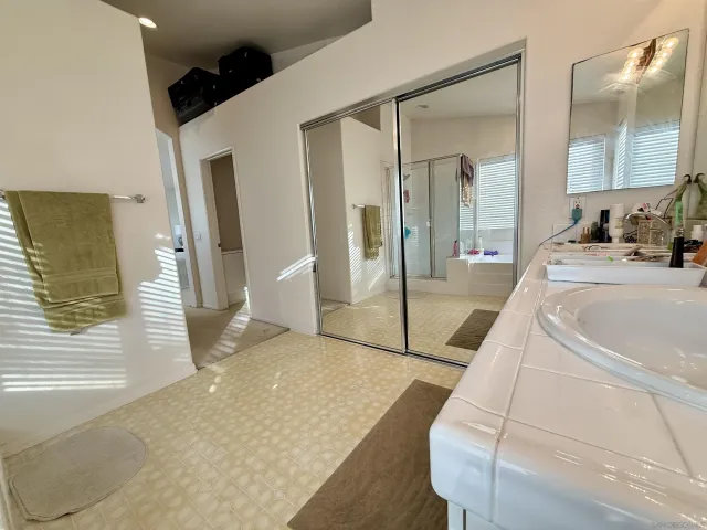 a en suite bathroom with a tub sink and glass door