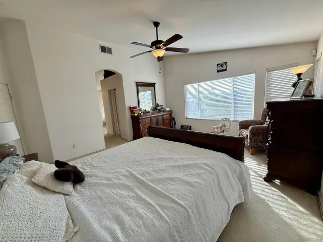 a bedroom with a bed and window