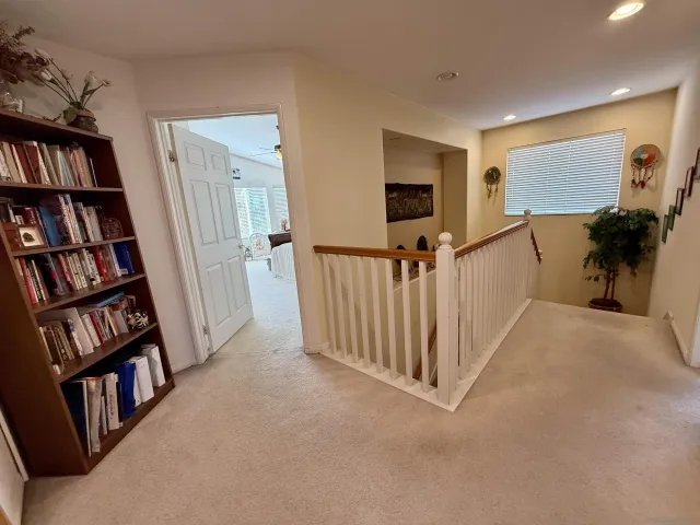 a view of a livingroom with furniture and staircase