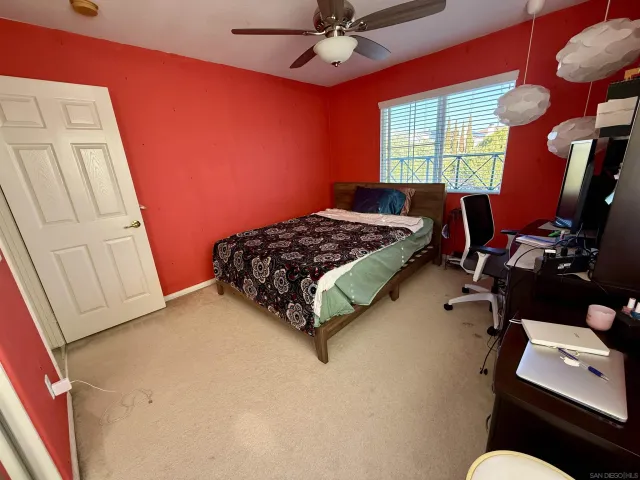 a bedroom with a bed dresser and a window