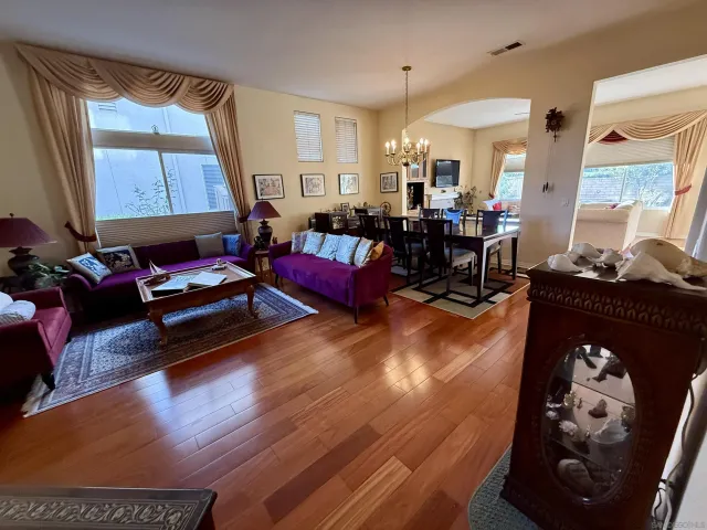 a living room with furniture a wooden floor and a fireplace