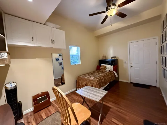 a bedroom with bed and a chandelier