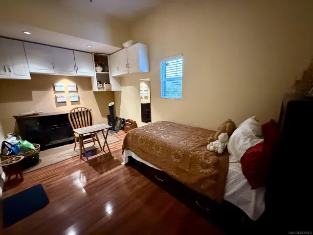 a bedroom with a bed chairs and a window